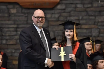 Female receives awards at graduation ceremony