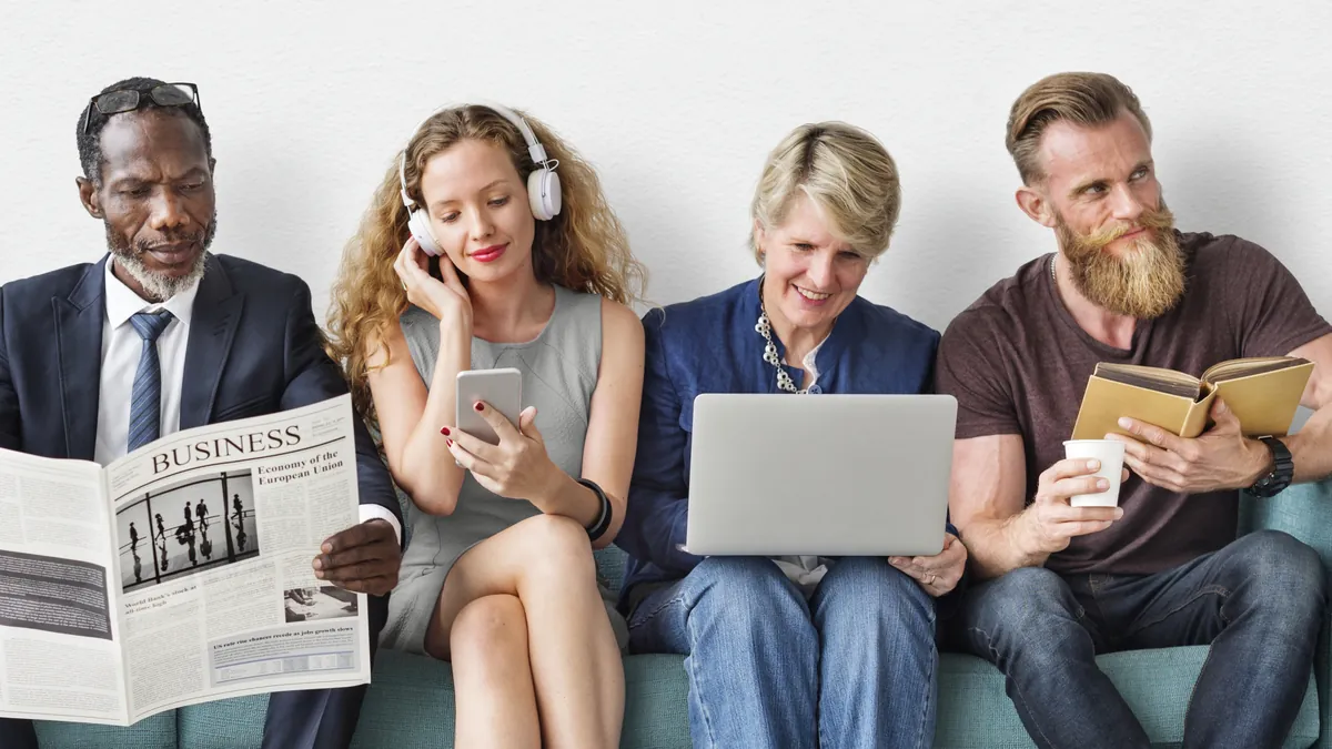 A group of people reading in various formats or listening on headphones.