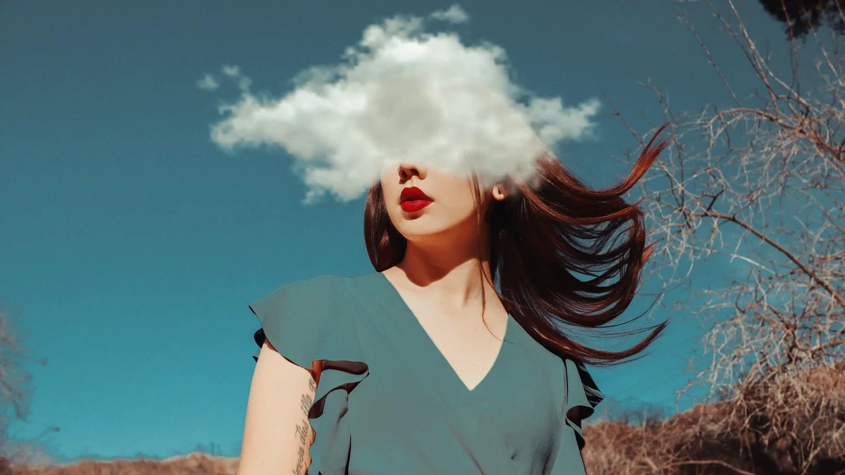 Woman with head in the clouds metaphorically