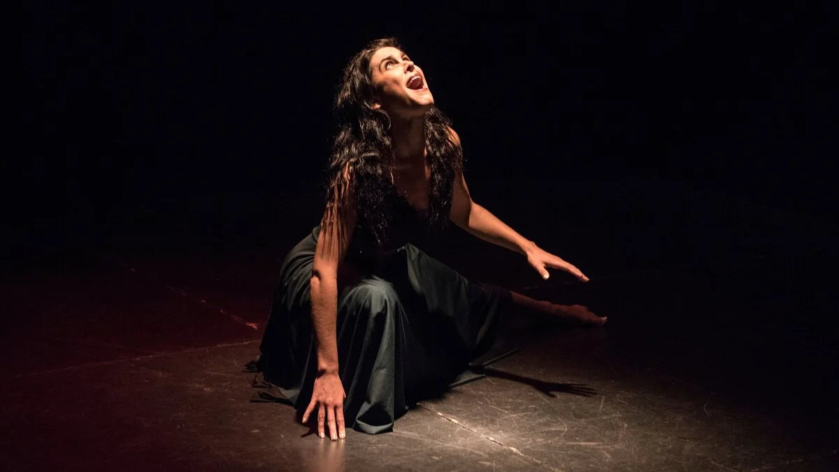 Woman expressing intensity, face like The Scream