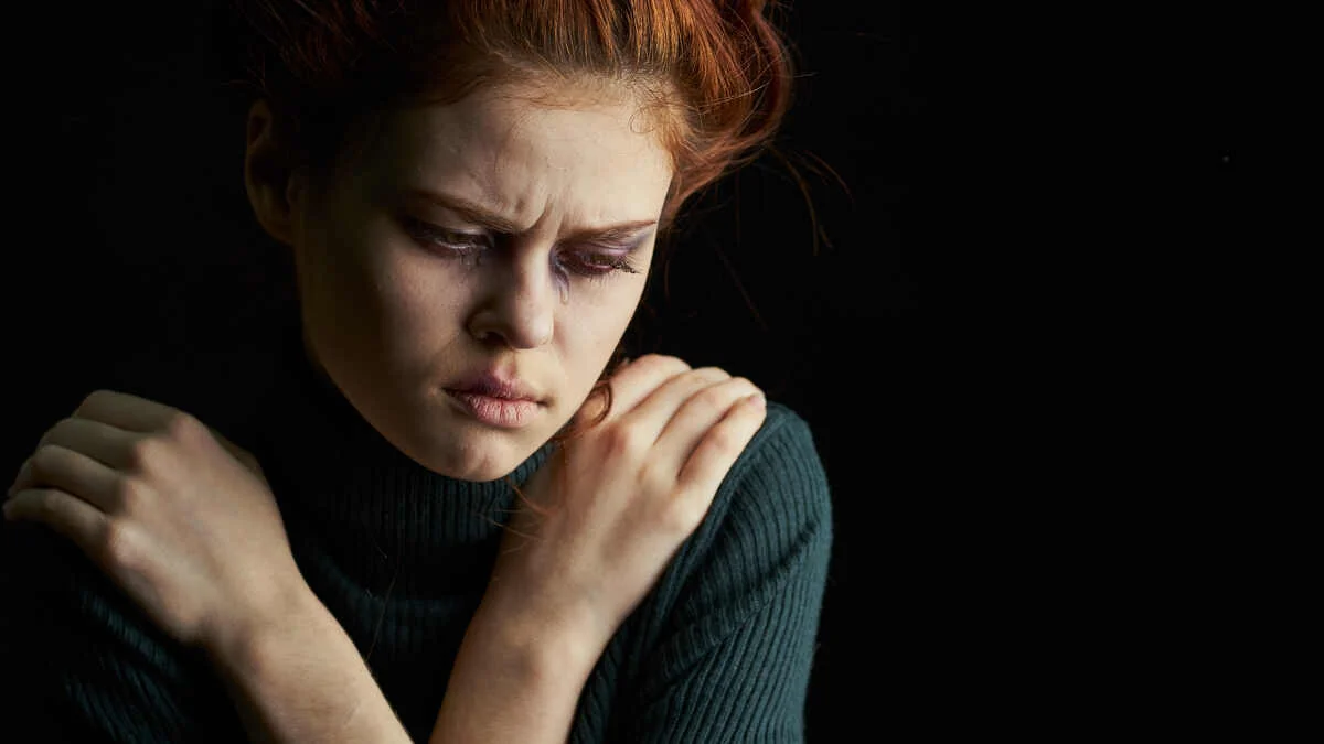 Woman looking down feeling down