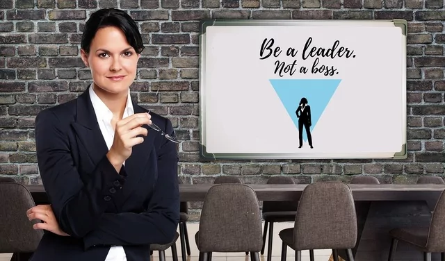 Woman leader with a sign that says, Be a Leader, Not a Boss