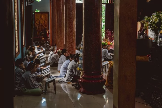 People meditating in a Buddhist temple