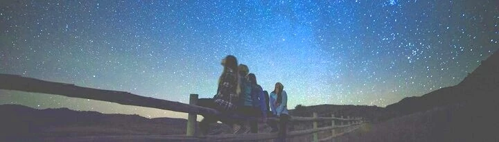 People looking up at the night sky from fate's gate.